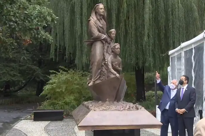 Governor Cuomo next to the newly unveiled statue of Mother Cabrini.